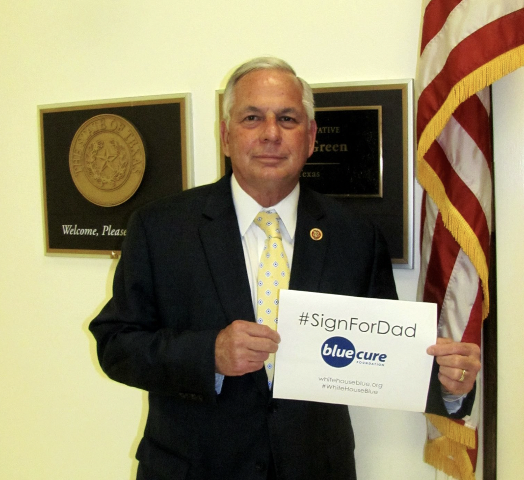 Congressman Gene Green holds Sign For Dad