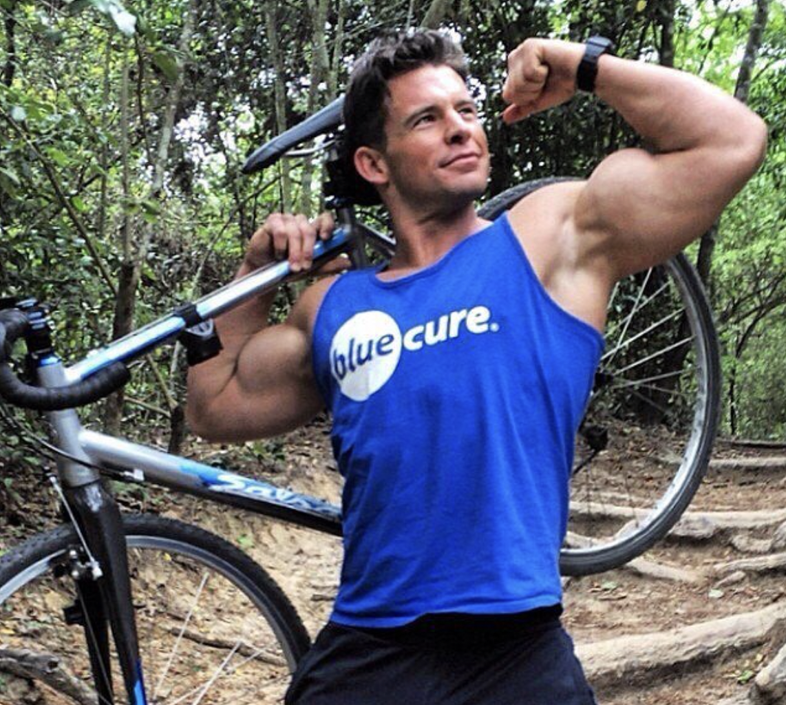 Supporter flexing with bike